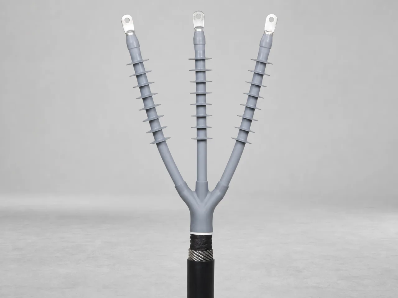 Brand-neutral generated catalog visual of Cold-shrink terminations: installed three-core cold-shrink termination with ribbed silicone bodies, breakout boot, insulated tails, and lugs.